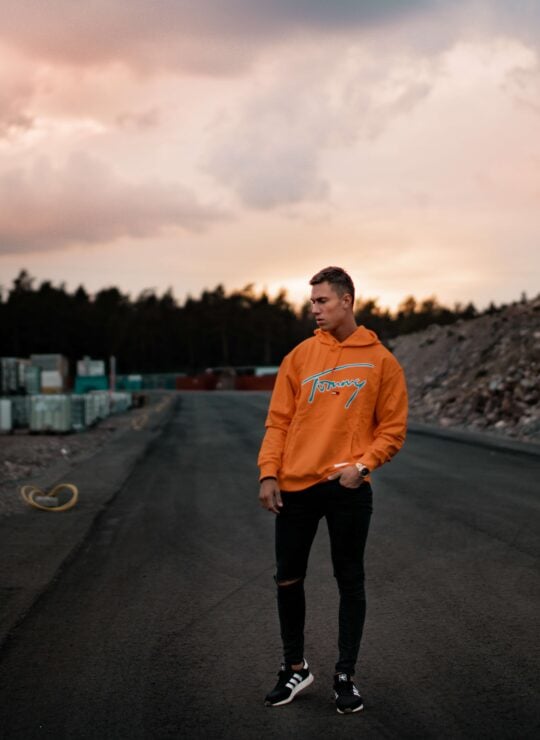 Man wearing an orange hoodie – custom & private label streetwear manufacturers in India producing high-quality hoodies for global brands.