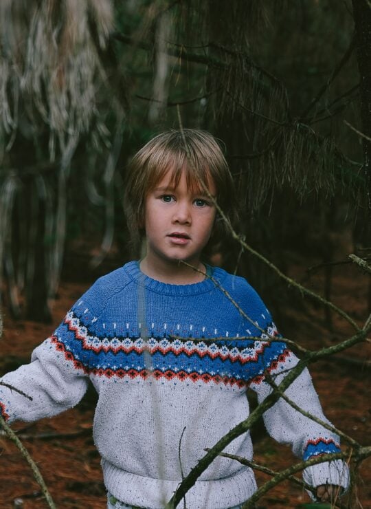 Boy wearing a full sleeve raglan T-shirt in forest by Synerg, leading boys T-shirt manufacturer and children’s T-shirts manufacturers & suppliers in India.