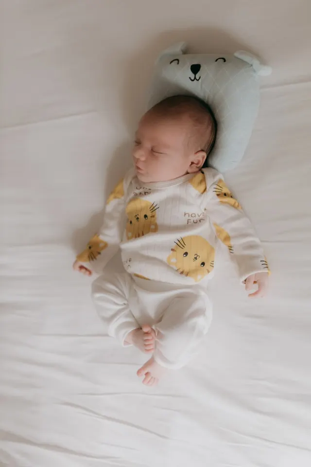 Baby wrapped in a soft sleeping bag designed by baby blanket manufacturers in India